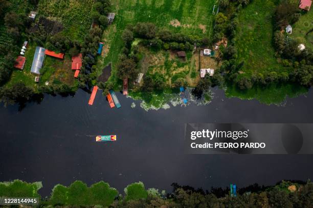 Aerial view of a "trajinera" at the Cuemanco canal in Xochimilco, a network of canals and floating gardens that is one of Mexico City's top tourist...