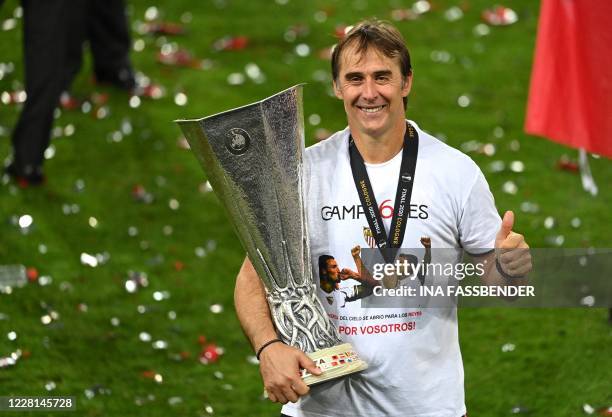 Sevilla's Spanish coach Julen Lopetegui holds the trophy after winning the UEFA Europa League final football match Sevilla v Inter Milan on August 21...