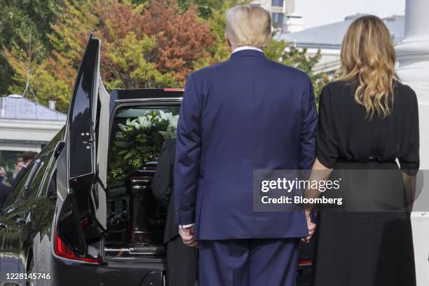 President Donald Trump and First Lady Melania Trump look on as Robert Trumps casket is loaded into a hearse at the North Portico of the White House...