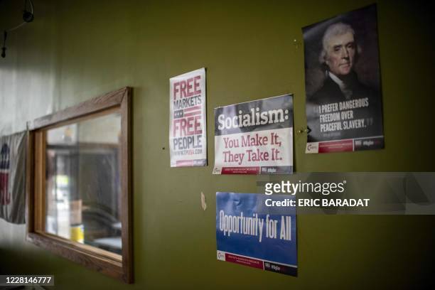 Signs against socialism are seen hanging on the wall as Republican Party Chairman for the Lackawanna County, Lance Stange , gives an interview to AFP...