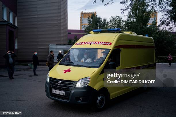 An ambulance carrying Russian opposition leader Alexei Navalny leaves Omsk Emergency Hospital No 1 where Navalny was admitted after he fell ill in...