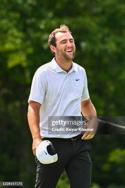 Scottie Scheffler smiles after making a birdie putt to card a 59 on the 18th hole green during the second round of THE NORTHERN TRUST at TPC Boston...