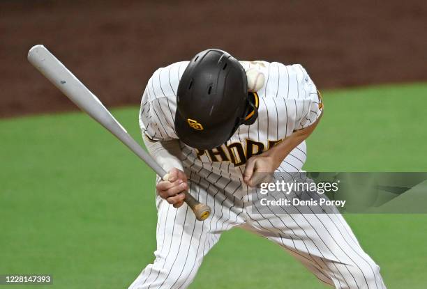 Wil Myers of the San Diego Padres is hit by a pitch during the fourth inning of a baseball game against the Houston Astros at Petco Park on August...