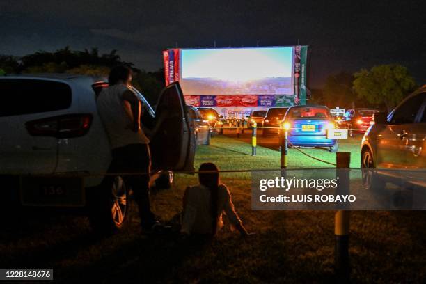 Couple watches a movie at a new drive-in cinema, amid the novel coronavirus, COVID-19 pandemic, in Cali, Colombia on August 21, 2020.