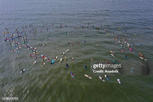 Drone photo shows surfers paddling out from Rockaway, New York to protest police injustice and in support of Black Lives Matter in New York, United...