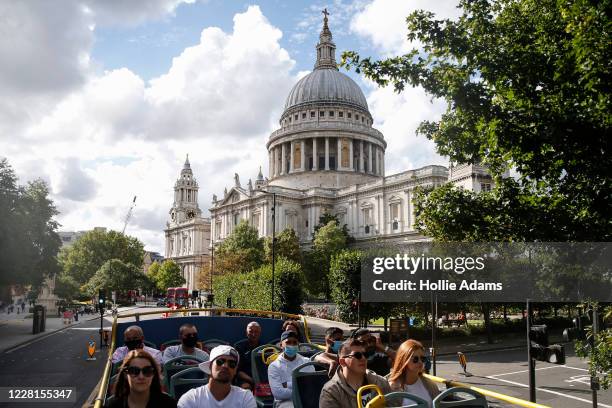 Tourists pass St. Paul's Cathedral on a sightseeing bus on August 22, 2020 in London, England. Whilst the UK is open for business to overseas...