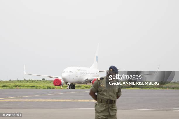 Malian soldier waits in front of the Malian Presidential aircraft on the runway of Bamako airport before a meeting between Malian military leaders...