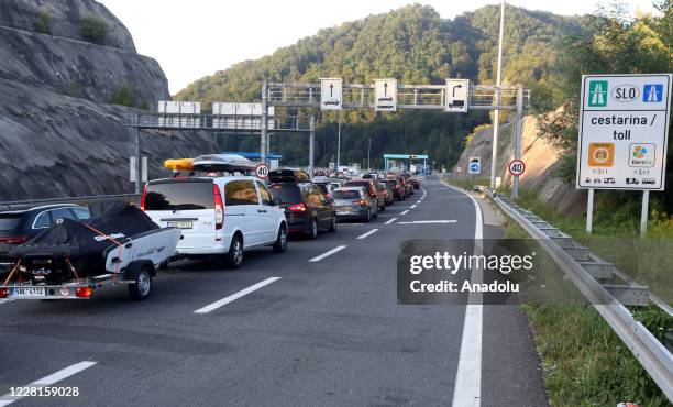 Vehicles, some from Austria, Slovenia and Germany, queue at the Macelj border crossing between Croatia and Slovenia, as many tourists take heed of a...