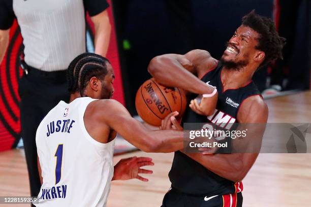Warren of the Indiana Pacers defends Jimmy Butler of the Miami Heat as he drives to the basket during the second half of Game 3 of an NBA basketball...