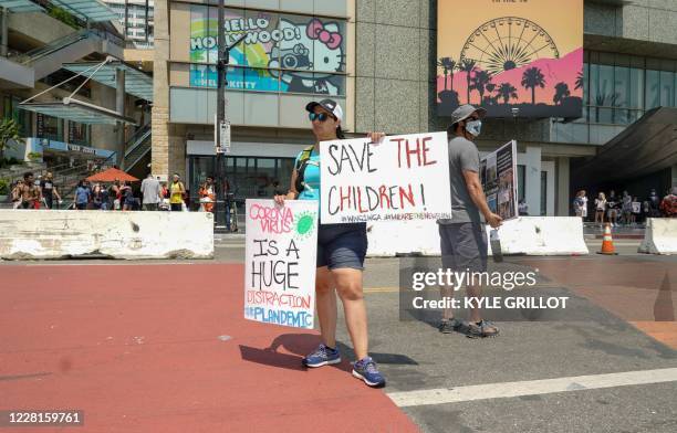 Conspiracy theorist QAnon demonstrators protest child trafficking on Hollywood Boulevard in Los Angeles, California, August 22, 2020. A 2019 bulletin...