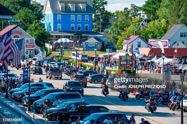 Motorcyclist and tourist cruise and walk the boardwalk along Lake Winnipesaukee at Weirs Beach during the 97th annual Laconia Bike Week in Laconia,...