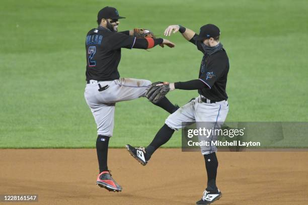 Jonathan Villar and Jon Berti of the Miami Marlins celebrates a win after game two of a doubleheader baseball game against the Washington Nationals...