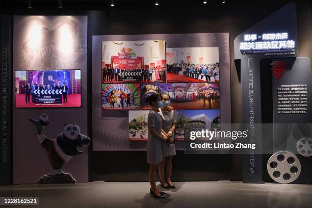 Museum employees wear protective face masks to guard against the spread of the coronavirus during the Beijing International Film Festival 10th...