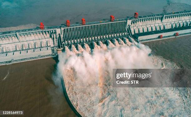 This aerial photo taken on August 23, 2020 shows water being released from the Three Gorges Dam, a gigantic hydropower project on the Yangtze river,...