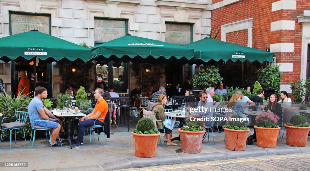 The Ivy Market Grill looks busy with people enjoying outdoor...