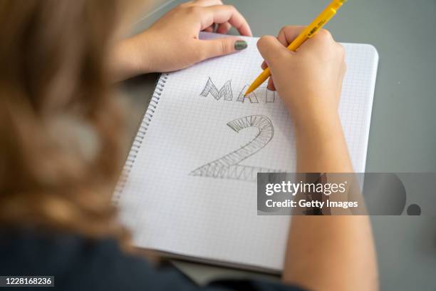 Student doodles in a notebook during mathematic class on the first day back to school since the March shut down at the Ostra Real public school on...
