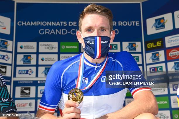 Gold medalist French Arnaud Demare poses with his medal for a photograph during the podium ceremony after winning the French Elite men road cycling...