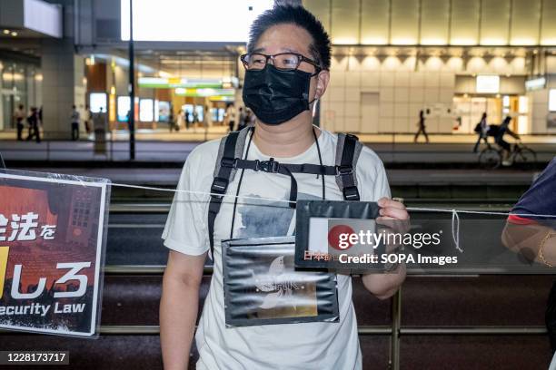 Demonstrator holding a Japanese national flag saying 'Japan support Hong Kong's Freedom' during the protest. Demonstrators took to the streets in...