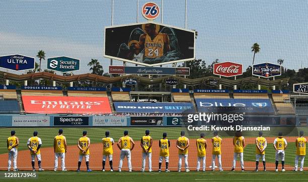 Los Angeles Dodgers and the Colorado Rockies line up with the Dodgers players wearing Kobe Bryant's Los Angeles Lakers jersey in honor of the late...