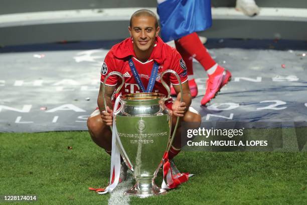 Bayern Munich's Spanish midfielder Thiago Alcantara celebrates with the trophy after the UEFA Champions League final football match between Paris...