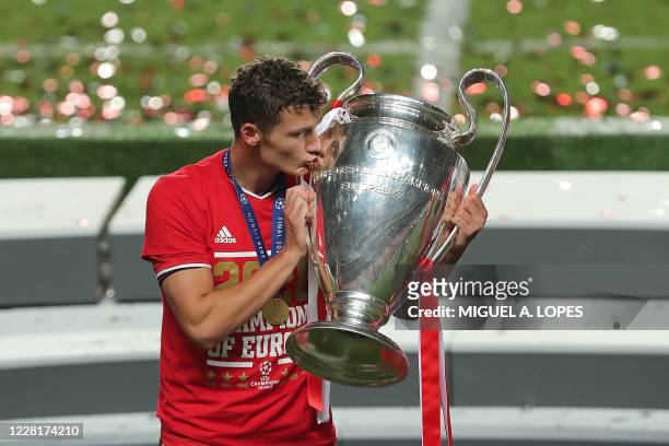 Bayern Munich's French defender Benjamin Pavard celebrates with the trophy after the UEFA Champions League final football match between Paris...