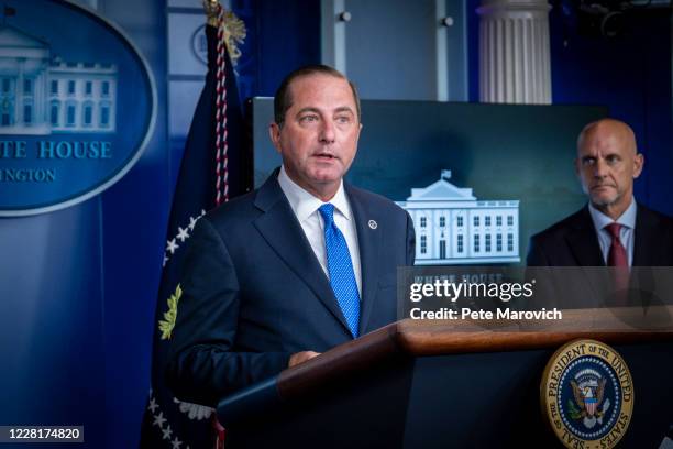 Commissioner Stephen Hahn looks on as Health and Human Services Secretary, Alex Azar, addresses the media during a press conference in James S. Brady...
