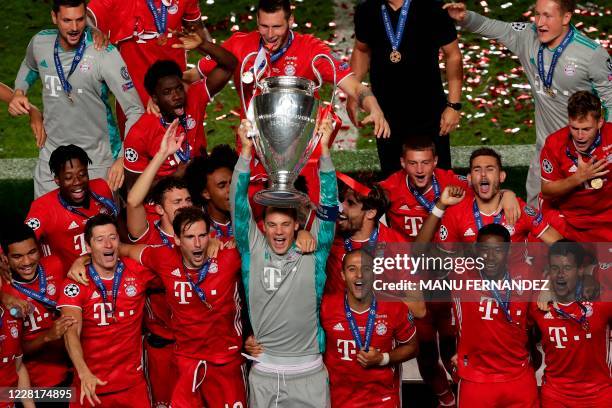 Bayern Munich's German goalkeeper Manuel Neuer celebrates with teammates and the trophy after Bayern won the UEFA Champions League final football...