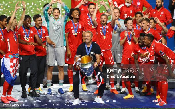 Players and head coach Hans-Dieter Flick of Bayern Munich celebrate at the end of the UEFA Champions League final football match between Paris...