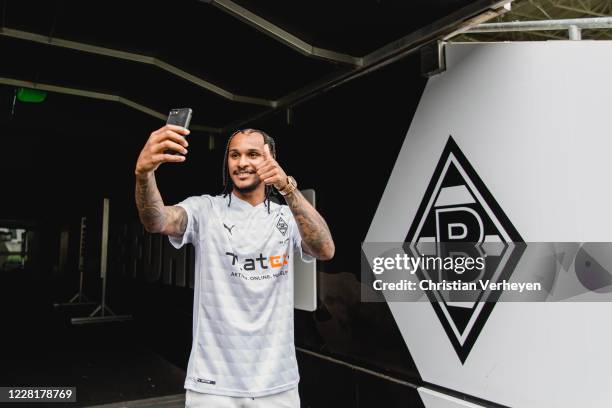 Valentino Lazaro pose with his jersey after he signs a new contract for Borussia Moenchengladbach at Borussia-Park on August 20, 2020 in...