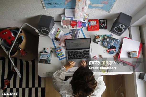 Woman works at an Apple Inc. Laptop computer on a desk in a children's bedroom in this arranged photograph taken in Bern, Switzerland, on Saturday,...