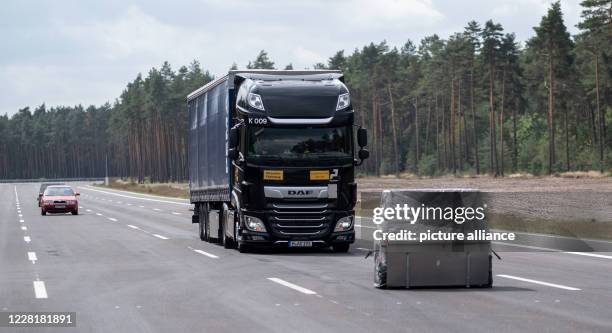 August 2020, Lower Saxony, Jeversen: A truck drives over a test track for commercial vehicles in Jeversen during emergency braking towards an...