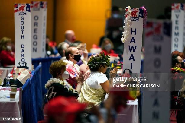Delegates from Hawaii, give their support to President Donald Trump during the opening of the first day of the Republican National Convention,...