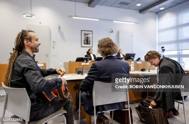 Jeroen Pols and Willem Engel sit in a court room during a hearing to claim documents on behalf of the Virus Truth Protest Group that form the basis...