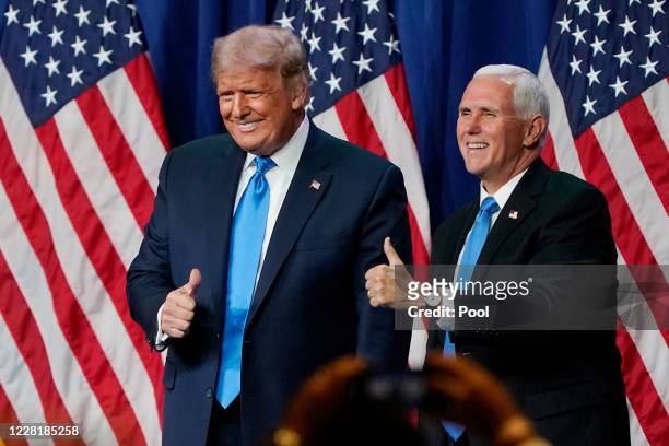 President Donald Trump and Vice President Mike Pence give a thumbs up after speaking on the first day of the Republican National Convention at the...
