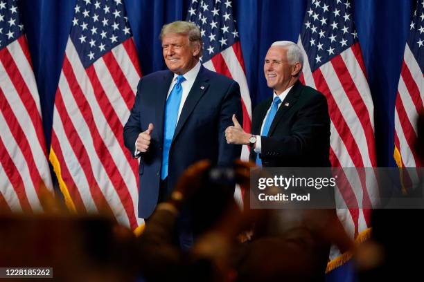 President Donald Trump and Vice President Mike Pence give a thumbs up after speaking on the first day of the Republican National Convention at the...