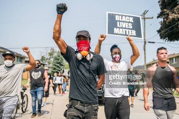 Demonstrators participate in a march on August 24, 2020 in Kenosha, Wisconsin. A night of civil unrest occurred after the shooting of Jacob Blake on...
