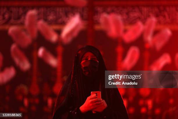 Muslim devotees, wearing masks and maintaining social distancing as a precaution for the novel coronavirus pandemic, take part in a mourning...