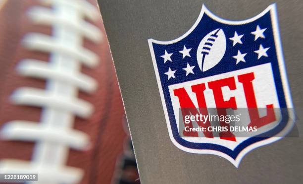 The NFL logo is seen on a football packaging in Los Angeles on August 24, 2020. - A rash of COVID-19 results that forced multiple NFL teams to adjust...