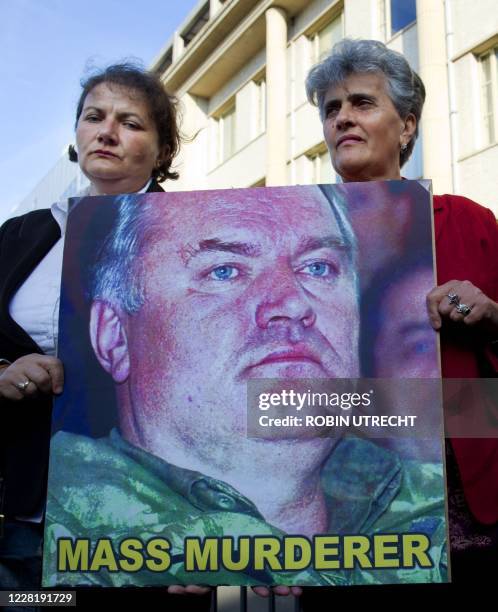 Relatives of people killed in 1995 Srebrenica massacre hold a picture of Bosnian Serb ex-army chief Ratko Mladic as they demonstrate in front of the...