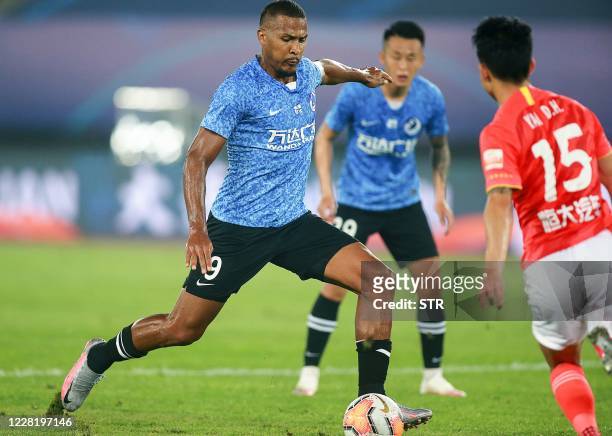 Dalian Pro's Jose Salomon Rondon kicks the ball during their Chinese Super League football match with Guangzhou Evergrande in Dalian, in China's...