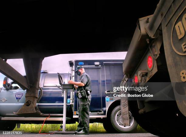 Troopers from the State Police's Commercial Vehicle Enforcement Unit weigh and inspect trucks at the Interstate 95 weigh station in Rowley, MA on...