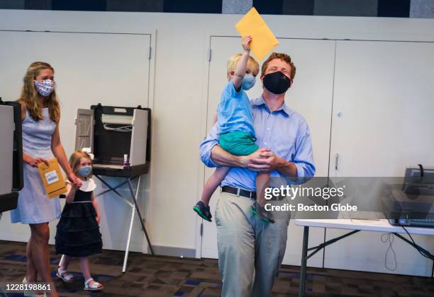 Year-old James Matthew holds up his father Congressman Joe Kennedy's ballot after the Kennedy family attended the early vote at the Newton Free...