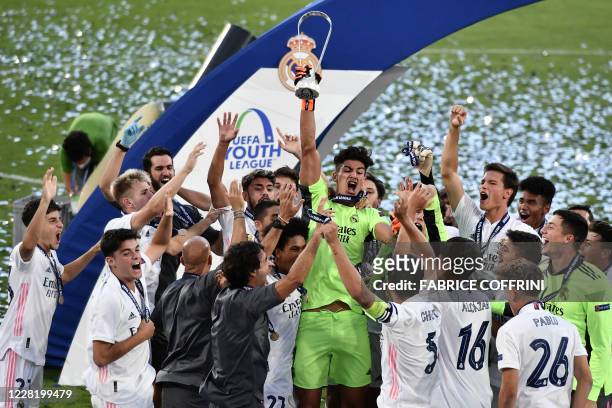 Real Madrid's players celebrates with the trophy their victory at the end of the football UEFA Youth League 2019/2020 final between Benfica and Real...