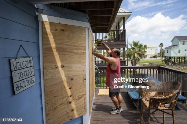 Resident boards up a window at a beach-front property ahead of Hurricane Laura in Galveston, Texas, U.S., on Tuesday, Aug. 25, 2020. Hurricane Laura...