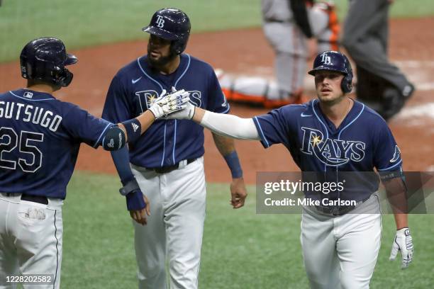 Hunter Renfroe of the Tampa Bay Rays celebrates his home run with Yoshitomo Tsutsugo and Jose Martinez against the Baltimore Orioles in the second...