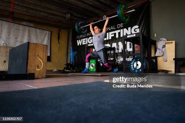 Brazilian Athlete Emily Rosa lifts weights during a training session at her coach makeshift garage gym on August 25, 2020 in Sao Paulo, Brazil. Emily...