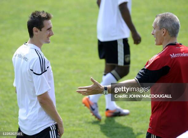 Germany's striker Miroslav Klose talks with fitness coach Marc Verstegen during a training session in Appiano, near the north Italian city of Bolzano...