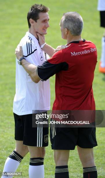 Germany's striker Miroslav Klose jokes with fitness coach Marc Verstegen during a training session in Appiano, near the north Italian city of Bolzano...