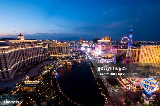 The Las Vegas Strip lights up at sunset in Las Vegas, Nev., on Sunday, Aug. 23, 2020.