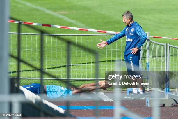 Salif Sane of FC Schalke 04 and Atheltic coach Werner Leuthard of FC Schalke 04 looks on during the FC Schalke 04 Training Camp on August 25, 2020 in...